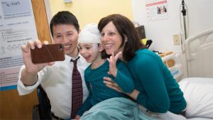 Photo of Dr. Yu taking a selfie with Mila and her mom