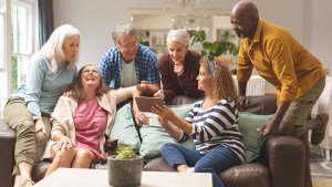 A group of older adults laugh together at something being said