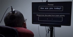 A man with an electrode on his head looks at a screen that says, "Prompt, How are you today?" "Response decoded from brain activity", (blank space)